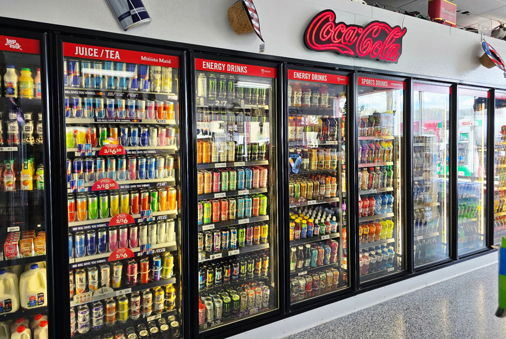 Shelves and fridges of snacks and drinks