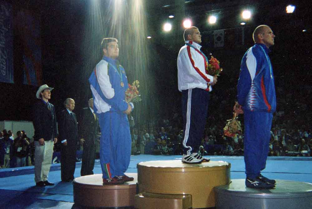 Rulon standing on podium after match