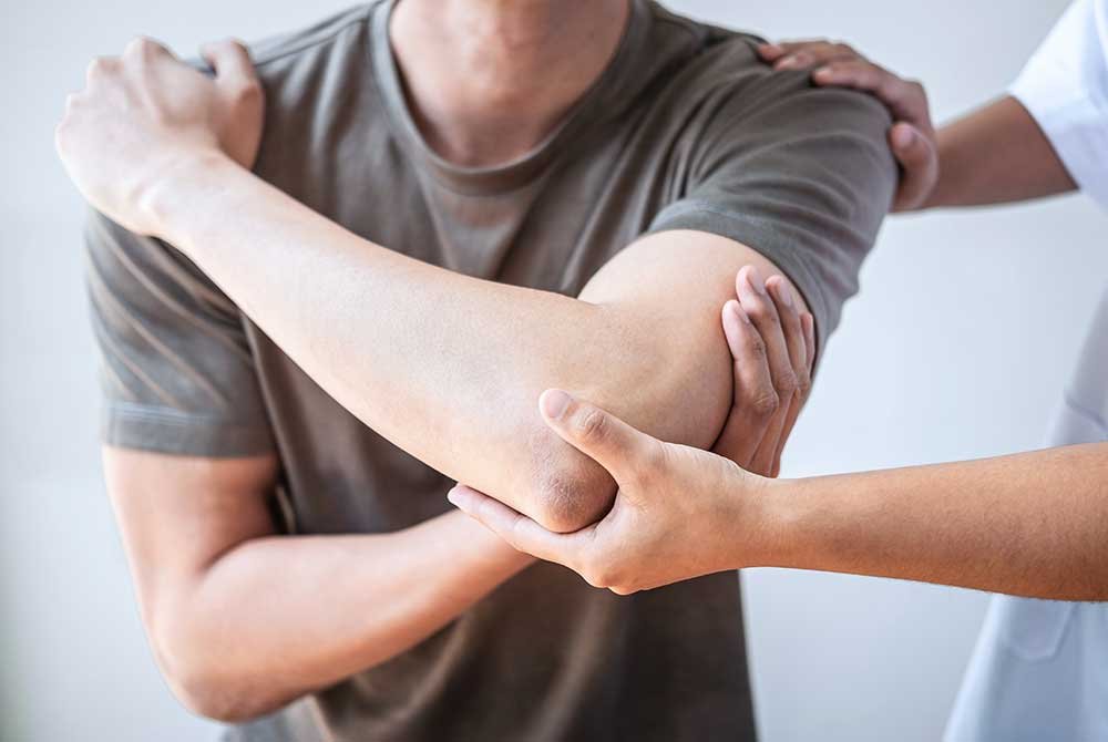 Man stretching arm and elbow
